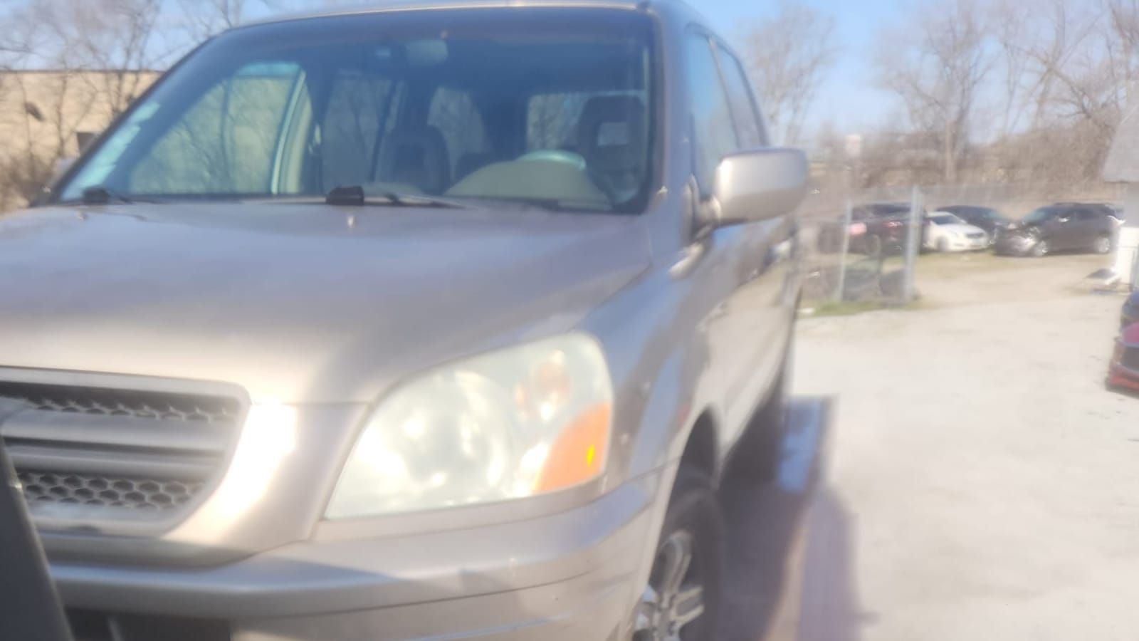 Silver SUV loaded on the deck of a flatbed tow truck